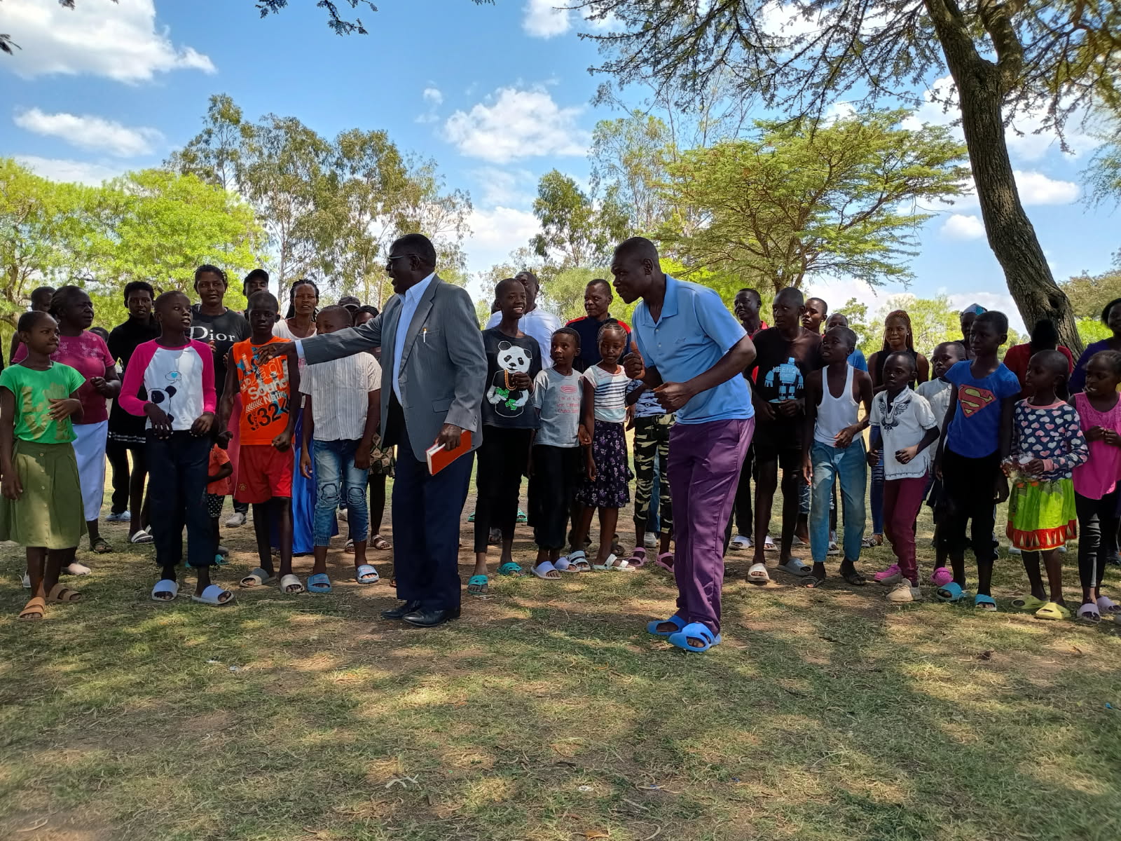 Large group of the Osiri Community Choir singing outside